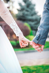 bride and groom holding hands