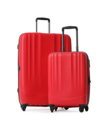 Red suitcases for travelling on white background