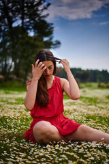 Red dress girl on daisy field