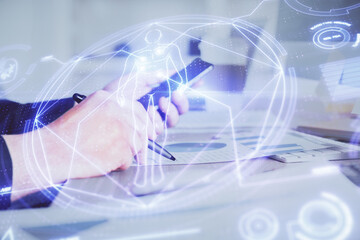 Double exposure of man's hands holding and using a phone and education theme drawing.