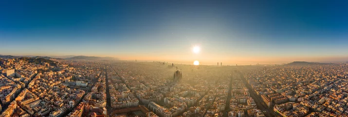  Aerial panorama drone shot of skyline in Barcelona city center in foggy sunrise golden hour in Spain winter © Davidzfr