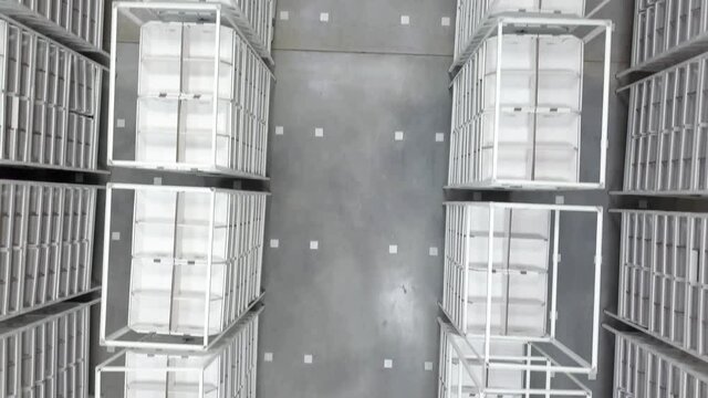 air flight over empty metal shelves in a logistics warehouse