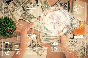 Multi exposure of technology drawing hologram and us dollars bills and man hands. Data concept