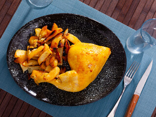 Tasty baked chicken and potatoes at plate