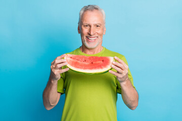 Portrait of satisfied person hands hold slice of watermelon toothy smile isolated on blue color background
