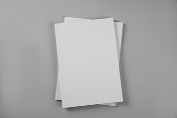 Blank brochures on grey background, top view. Mockup for design