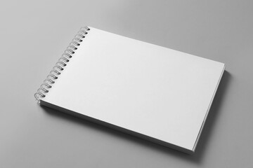 Blank notebook on light grey background. Mockup for design