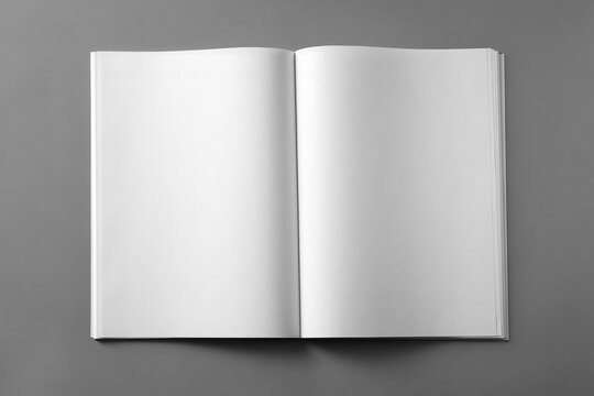 Open blank brochure on light grey background, top view