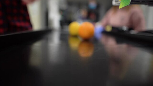 A woman's hand lays out the goods on the tape near the cash register. Buying fruit in the supermarket. Pay for the goods.