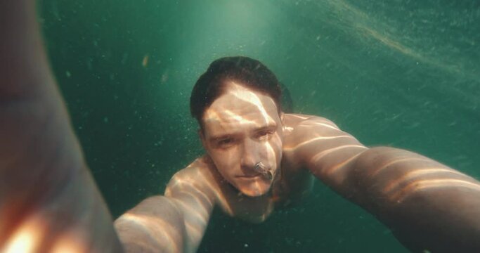 guy diving underwater ocean holiday