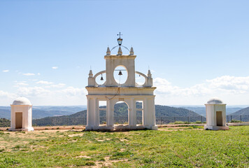 White arch of Steeple and sentry boxes in the interpretation center of the peña de arias montano in Alajar, Huelva,Spain - obrazy, fototapety, plakaty