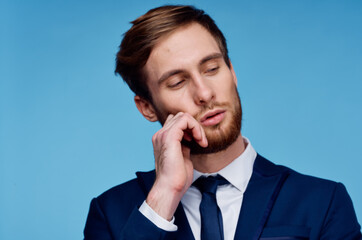 business man in suit cropped view blue background close-up