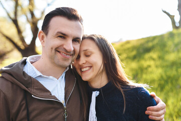 man hugging woman with closed eyes