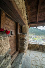 old house in the mountains and red rose