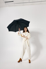 pretty woman white suit open umbrella modern style fashion