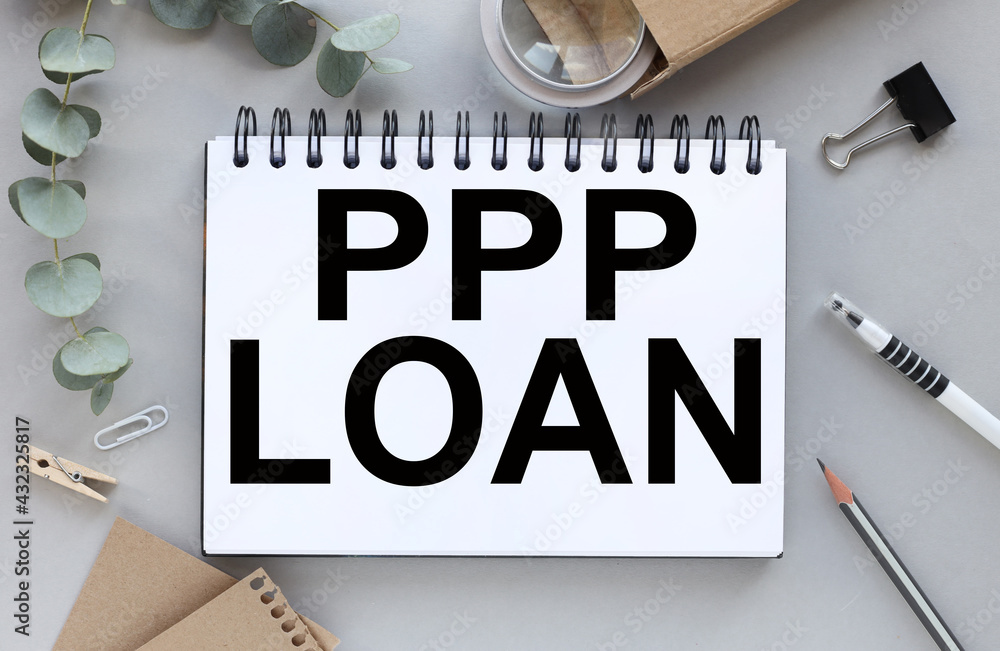 Poster notebook with the text paycheck protection program ppp loan. magnifying glass and plant near notepad