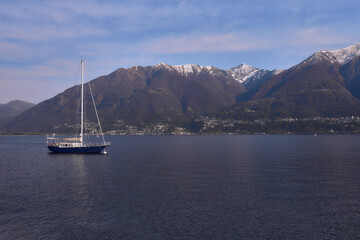 Fototapeta premium Boat on the lake with mountains view in Switzerland