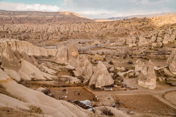 Fototapeta na wymiar Beautiful view of a horse ranch with unique rock formations and typical fairy chimneys in Göreme, Cappadocia, Turkey