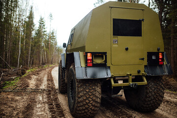 a four-wheel drive all-terrain vehicle drives through the forest through the mud. a passable SUV...