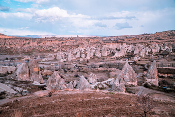 Fototapeta premium Spectacular panoramic sunset view of unique rock formations and typical fairy chimneys in Göreme, Cappadocia, Turkey