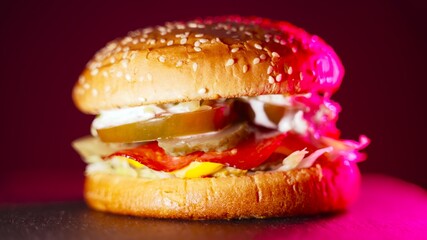 Rustic homemade hamburger with neon backlight.