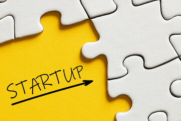 The word startup surrounded by puzzle pieces. Business or company startup