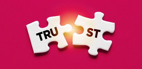 Two puzzle pieces with the word Trust. Broken trust, to violate agreements, to lose credibility and...