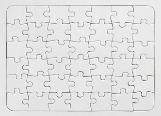 White jigsaw puzzle background. Overhead view with copy space.