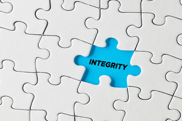The word integrity written on missing puzzle piece.