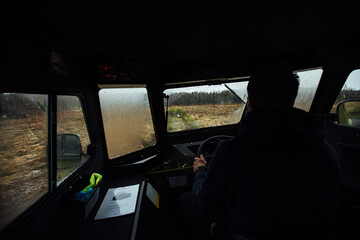 the driver is driving off-road. view from the interior of a four-wheel-drive car on a dirt road. dangerous passage of the trophy raid. extreme driving