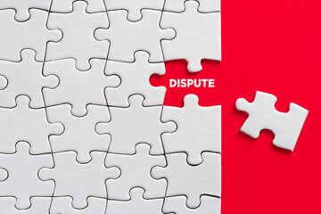 The word dispute written on missing puzzle piece on red background. Dispute resolution or to reveal...