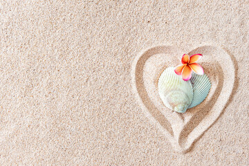 Fototapeta na wymiar Two seashells in the shape of a heart on a smooth sandy beach with copy space, top view