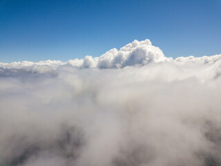 Fototapeta na wymiar Flying in the clouds. Aerial high view.