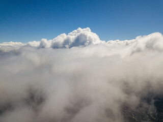 Fototapeta na wymiar Flying in the clouds. Aerial high view.