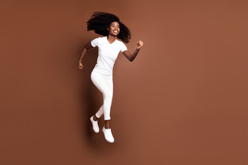 Fototapeta na wymiar Full size profile portrait of carefree dark skin person hurry look empty space isolated on brown color background