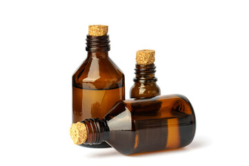 three cosmetic bottles with a stopper on a white. brown bottles full of liquid used in cosmetics and medicine.