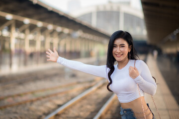 Asian female tourists are taking her to places of joy, emotional excitement, using public rail transport.