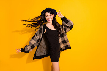 Photo of stunning charming young woman fly hair wear glamour outfit isolated on bright yellow color...