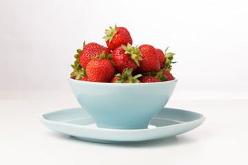 Red strawberries in blue cups