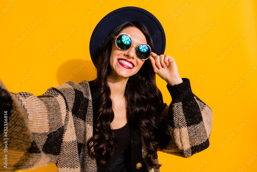 Sticker Photo of positive lady take selfie toothy beaming smile wear specs black hat plaid jacket isolated yellow color background