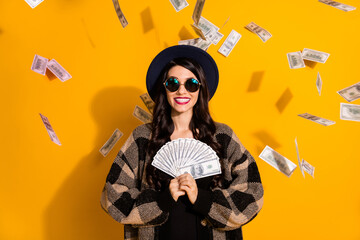 Photo of wealthy positive lady hold fan cash shiny smile wear eyeglasses hat plaid jacket isolated...