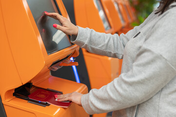 Traveler using a self check-in machine kiosk service at airport, Close up of finger point on...