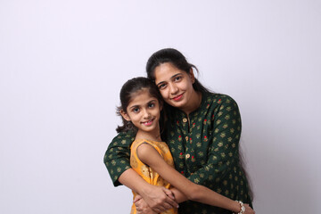 Indian mother daughter on white background. mothers day