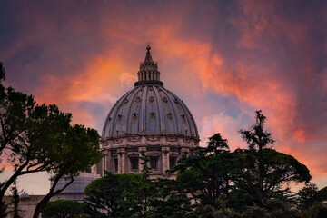 Saint Peter dome in Vatican City, with clouds and sunset light