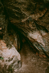 Small sandstone cave in Licu Langu sandstone cliffs in Latvia near Gauja river