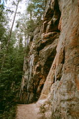 Hiking trail by the Licu and Langu sandstone cliffs by the Gauja river in Latvia