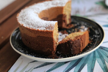 Marble cake cup of coffee powder sugar, closeup
