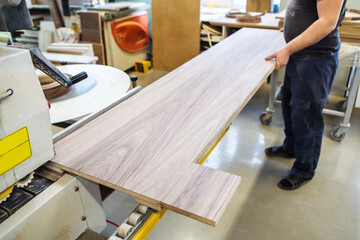 Furniture manufacturing. The process of applying pvc edging to veneered panels. Unrecognizable...