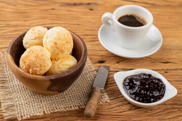 Typical brazilian cheese bun in a basket, coffee and jam