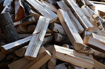 Stocks of birch firewood. Harvesting firewood for the winter. Background of firewood